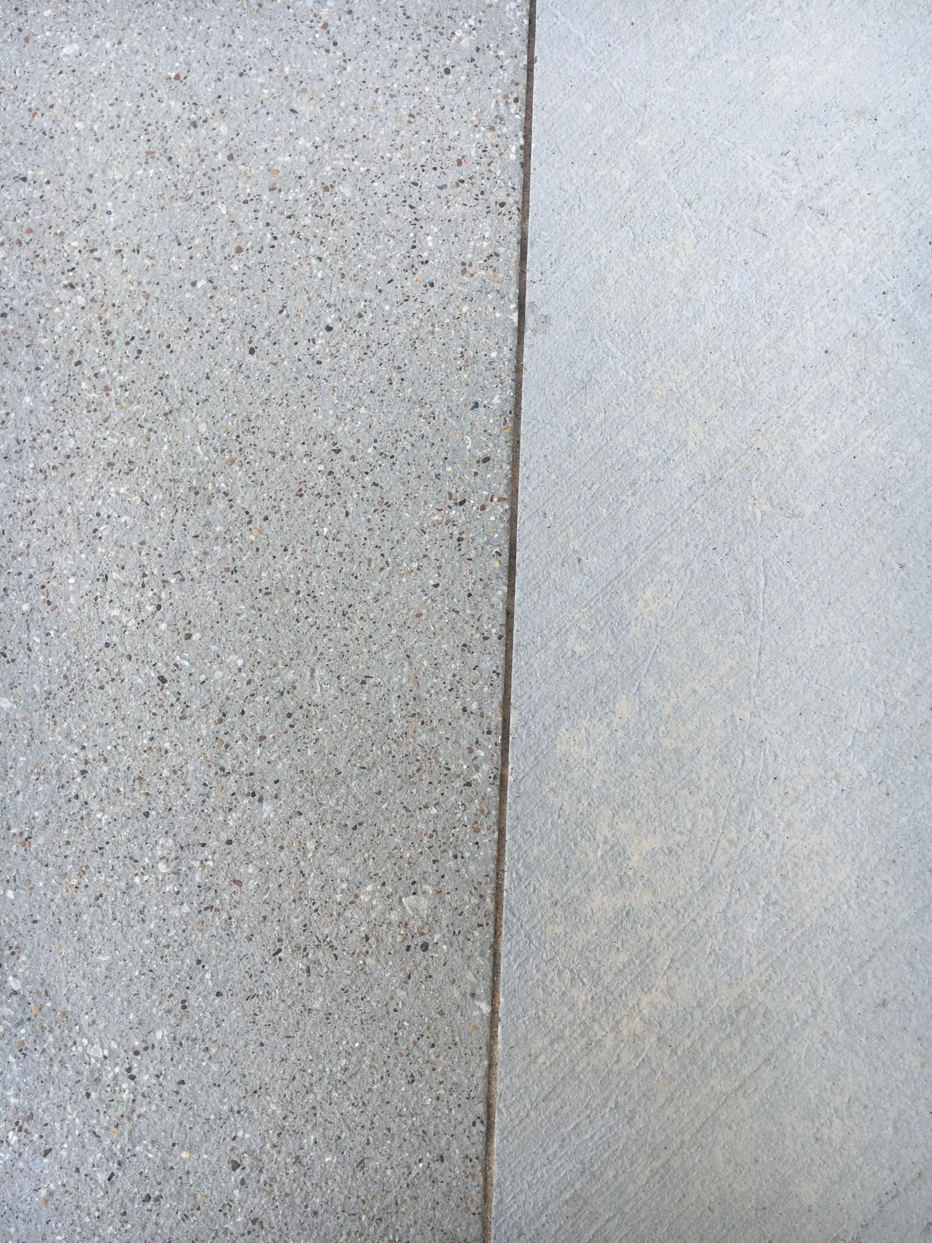 A man is sandblasting a piece of metal.