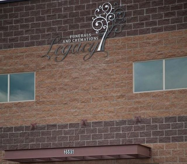 Building exterior with a sign reading “Veterans and Generations” above brick walls and windows
