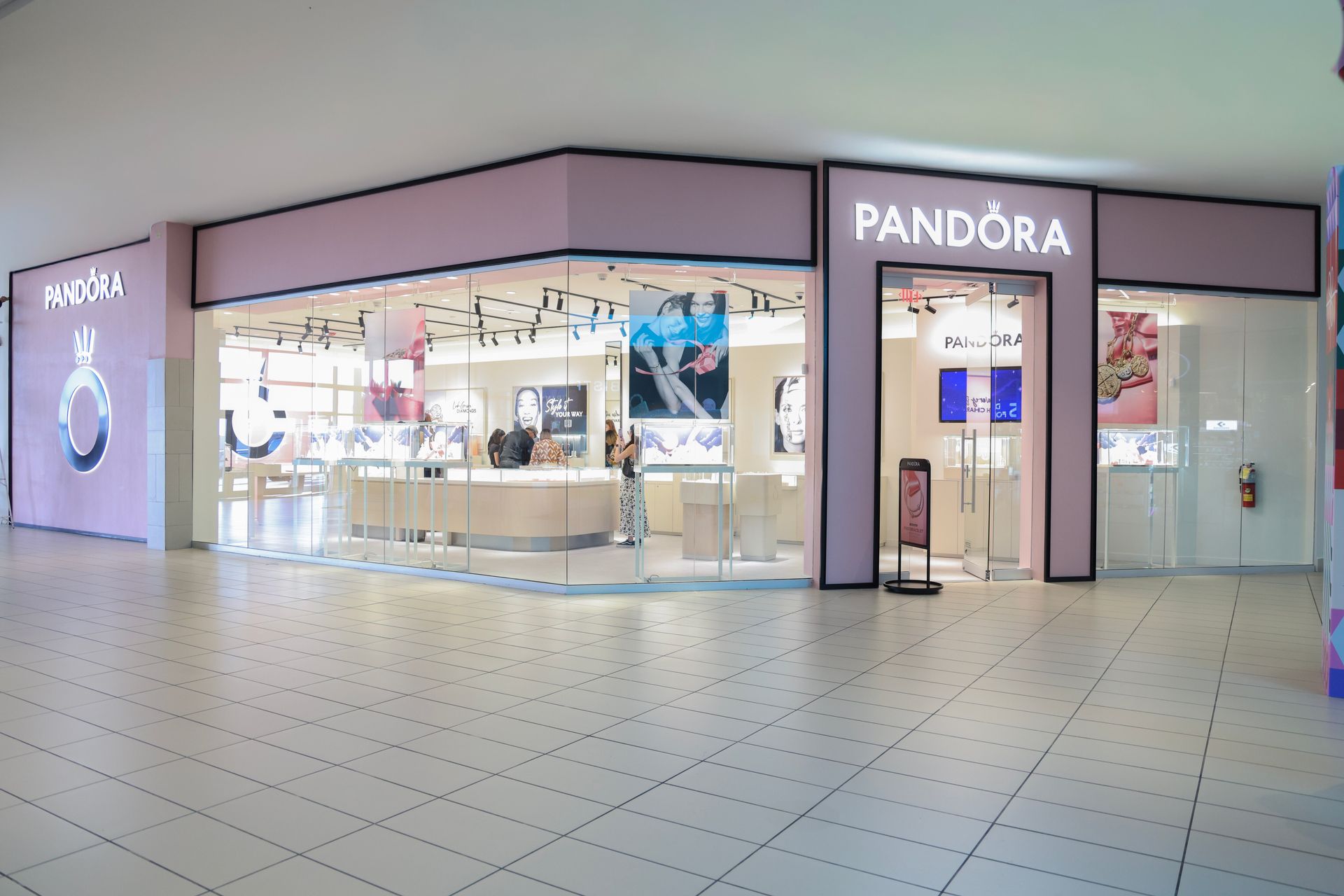 Pandora jewelry store in a mall with a pink exterior.
