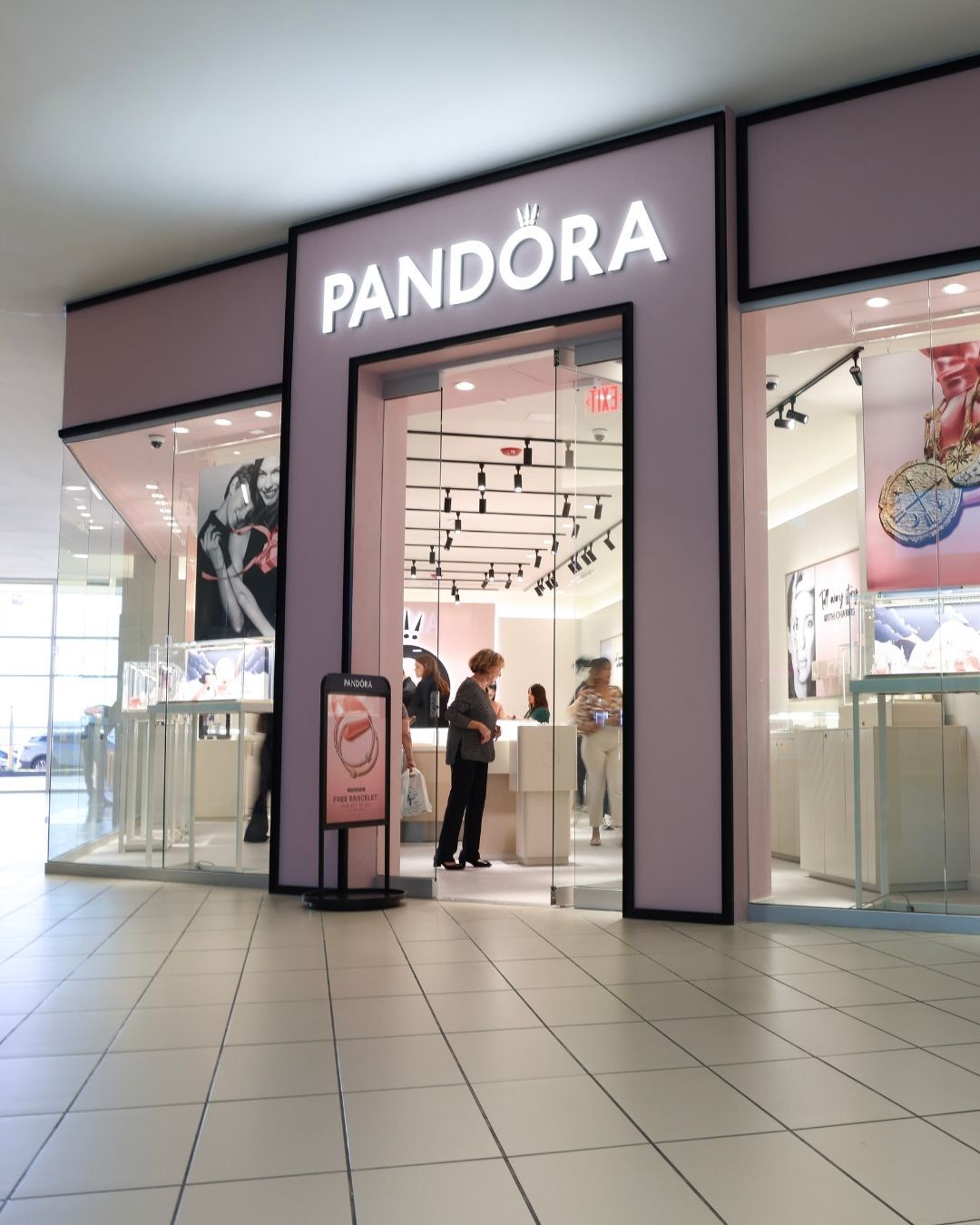 A collage showing three free public phone charging stations in a shopping mall setting with purple and blue digital signs.
