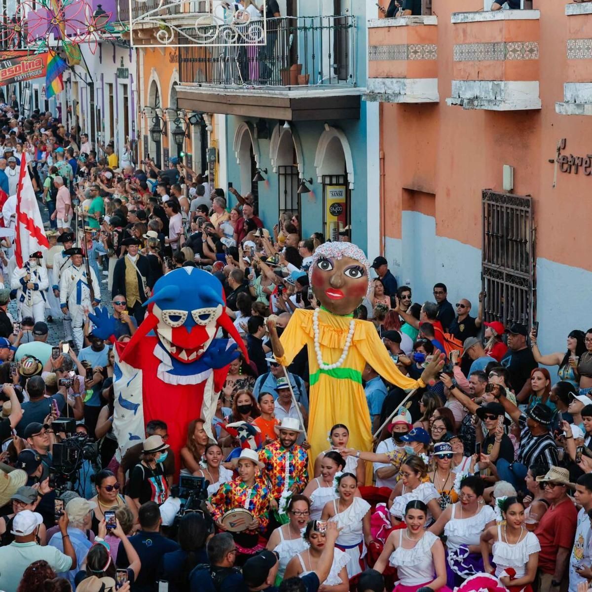 Street festival with large puppets and crowd in San Juan, Puerto Rico.