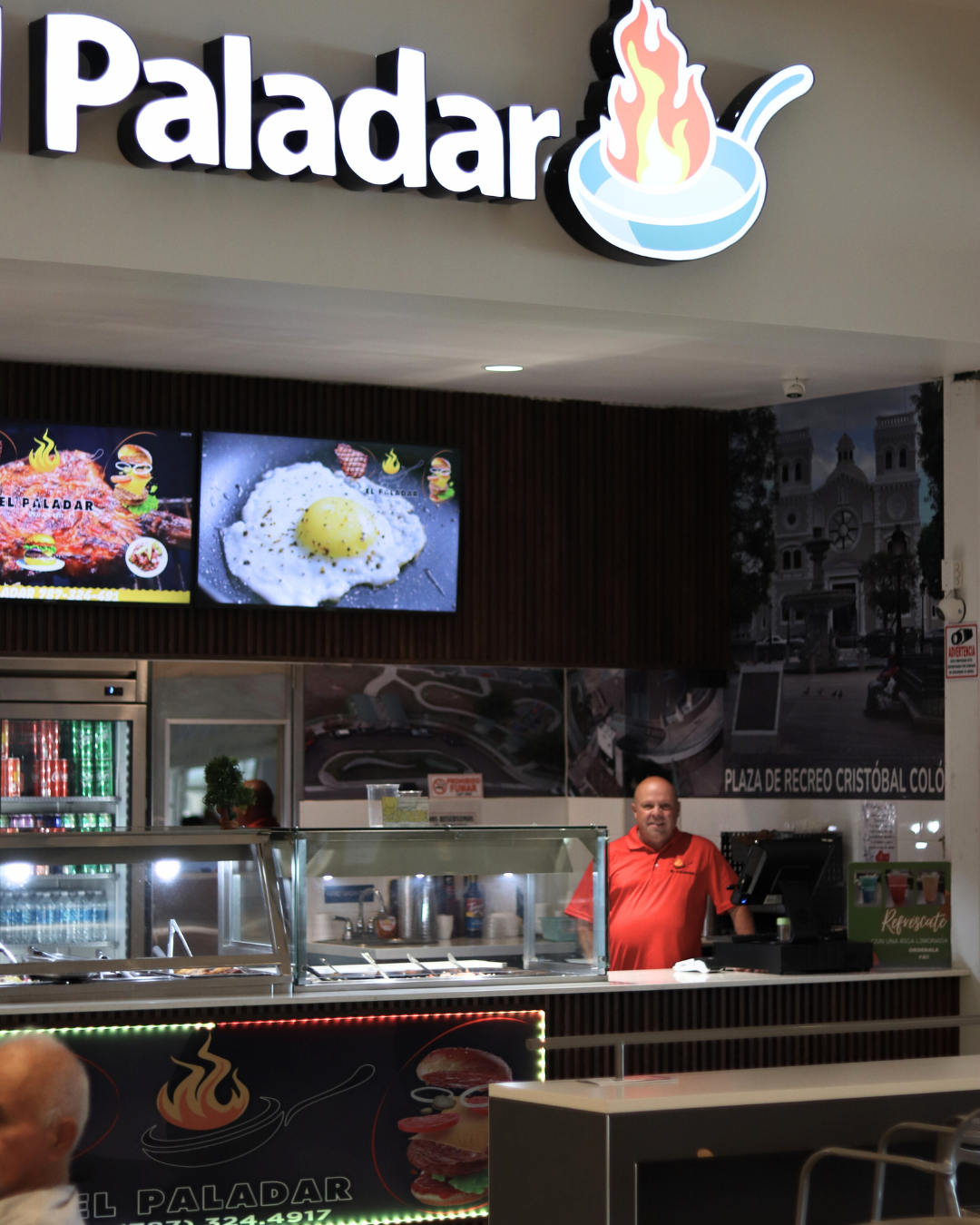 Burger with sweet potato fries in a takeout container.