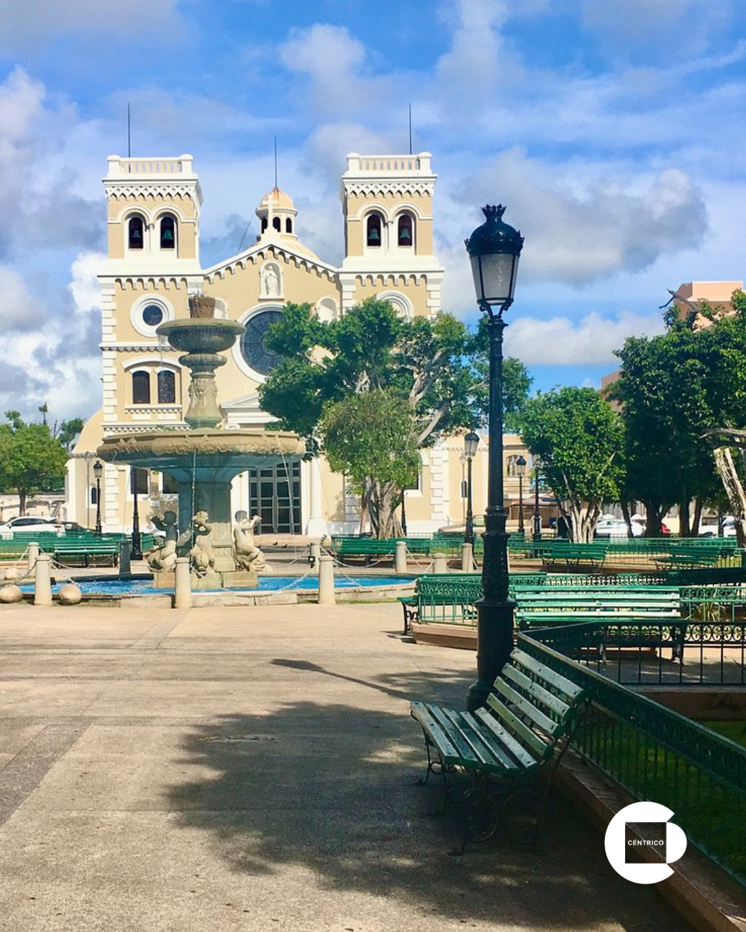 Aerial view of a coastal town with a white cylindrical building and the ocean.