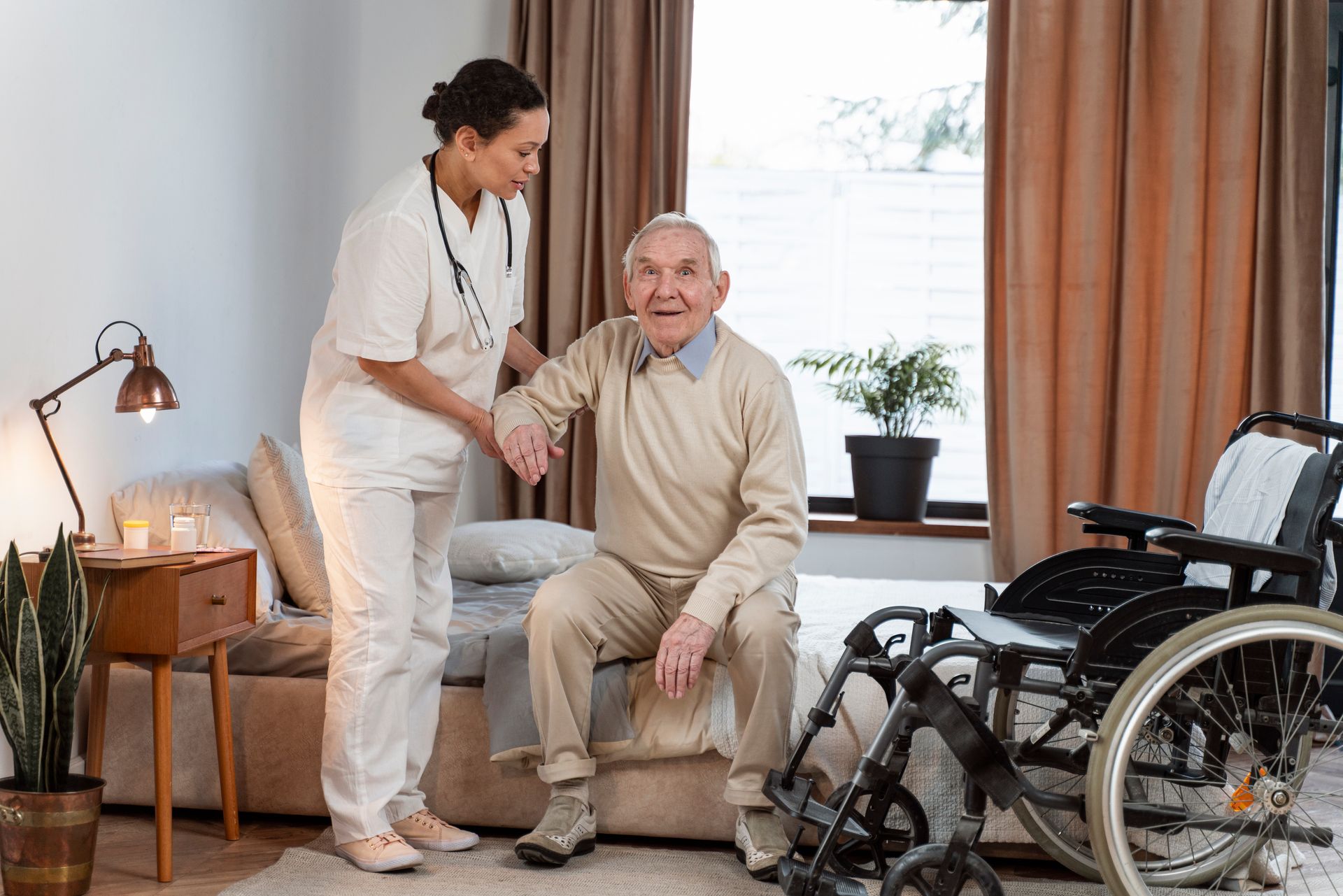 NDIS disability support worker assisting elderly man to stand from bed in a home care setting