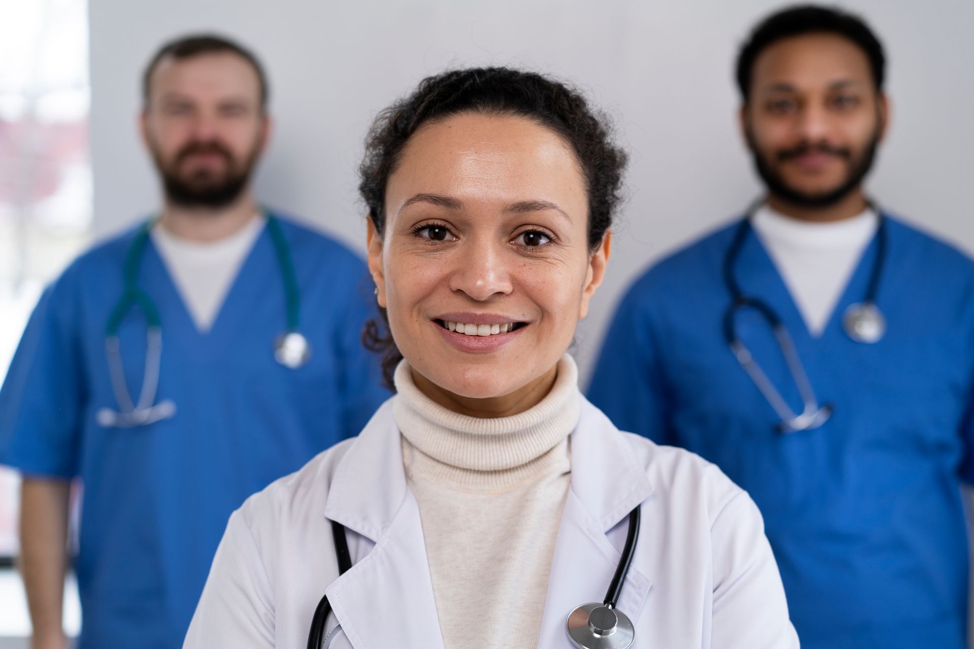 Smiling allied health professionals posing for a team photo