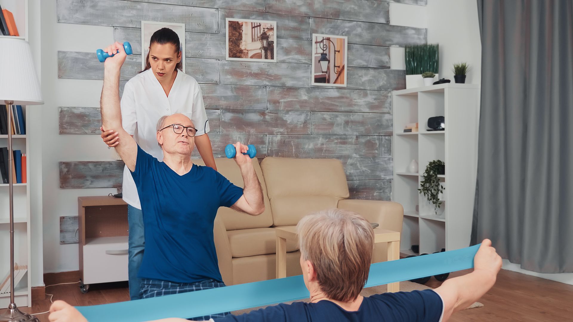 Elderly man guided by physiotherapist during home rehab, reflecting rising physiotherapy demand
