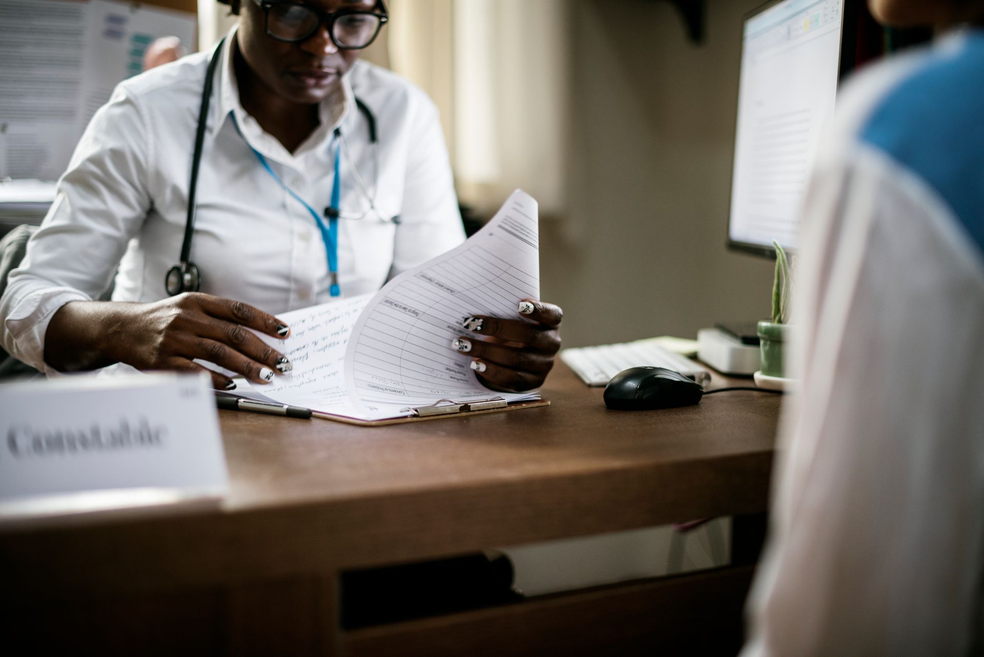 Healthcare worker reviewing documents at desk from candidates applied for short term nursing contracts in Australia