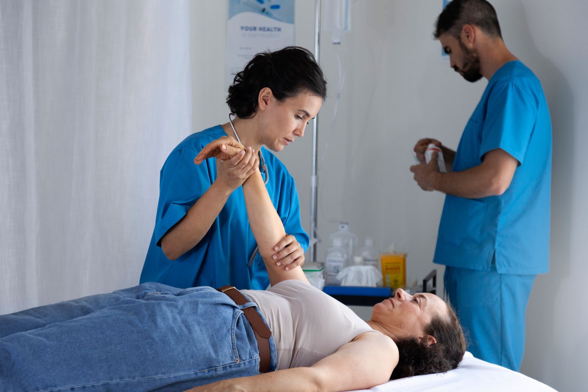 Allied health job in action as a practitioner treats a patient’s arm