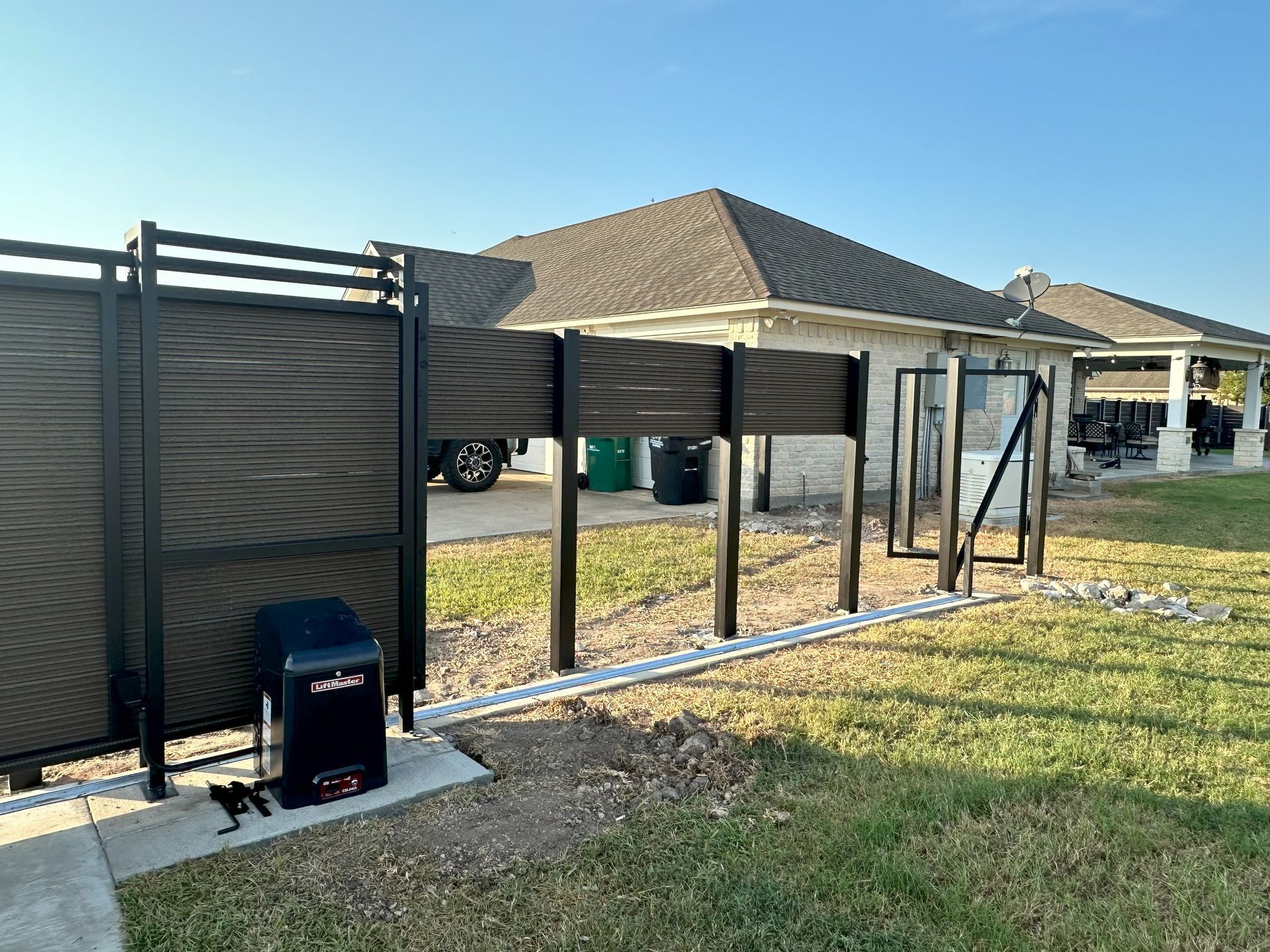 A metal building with a garage door is being built in a field.