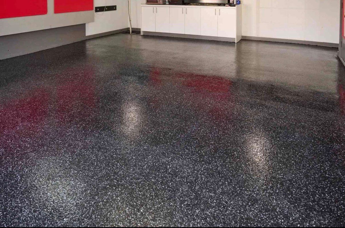 Dark speckled epoxy garage floor.