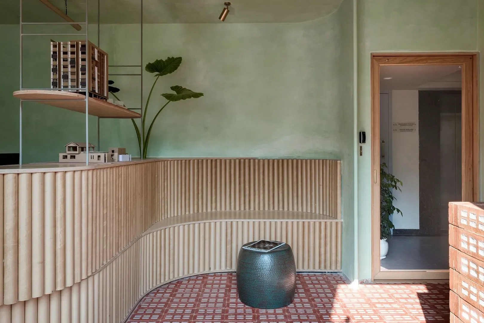 White kitchen with island, cabinets, stainless steel appliances, and wood flooring.