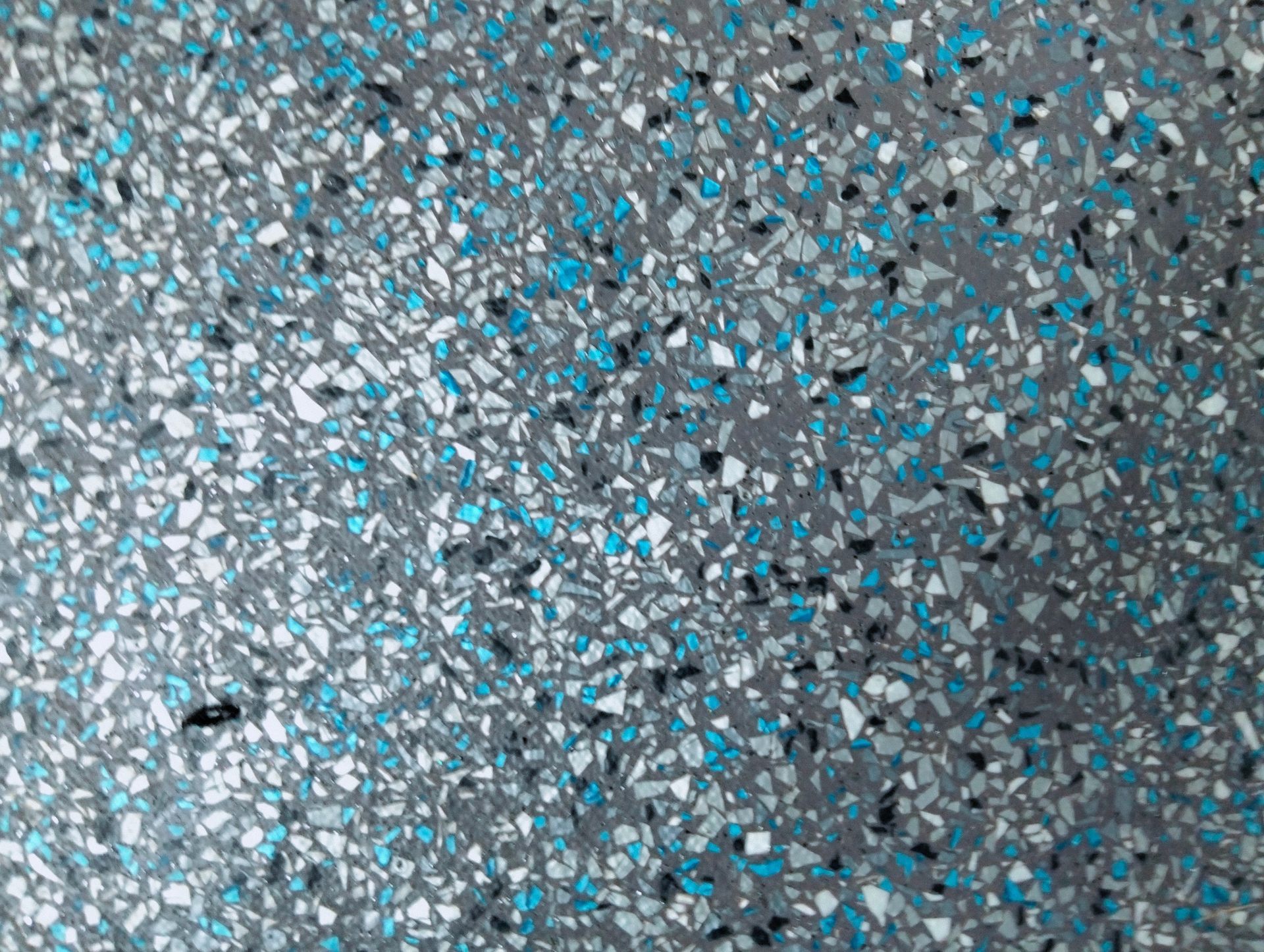 Gray terrazzo floor with blue, white, and black flecks.