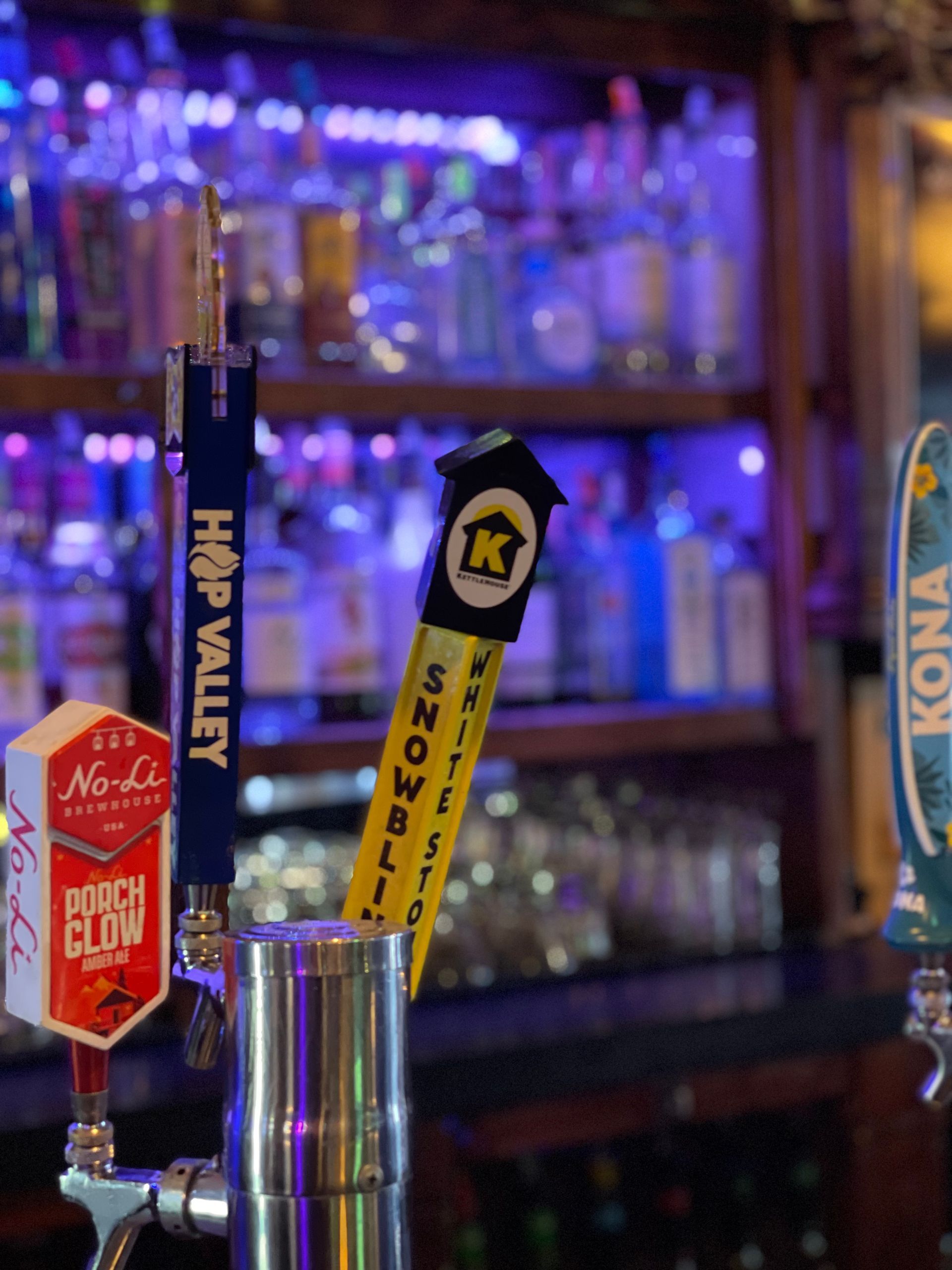 A bar with a tap that says kona on it