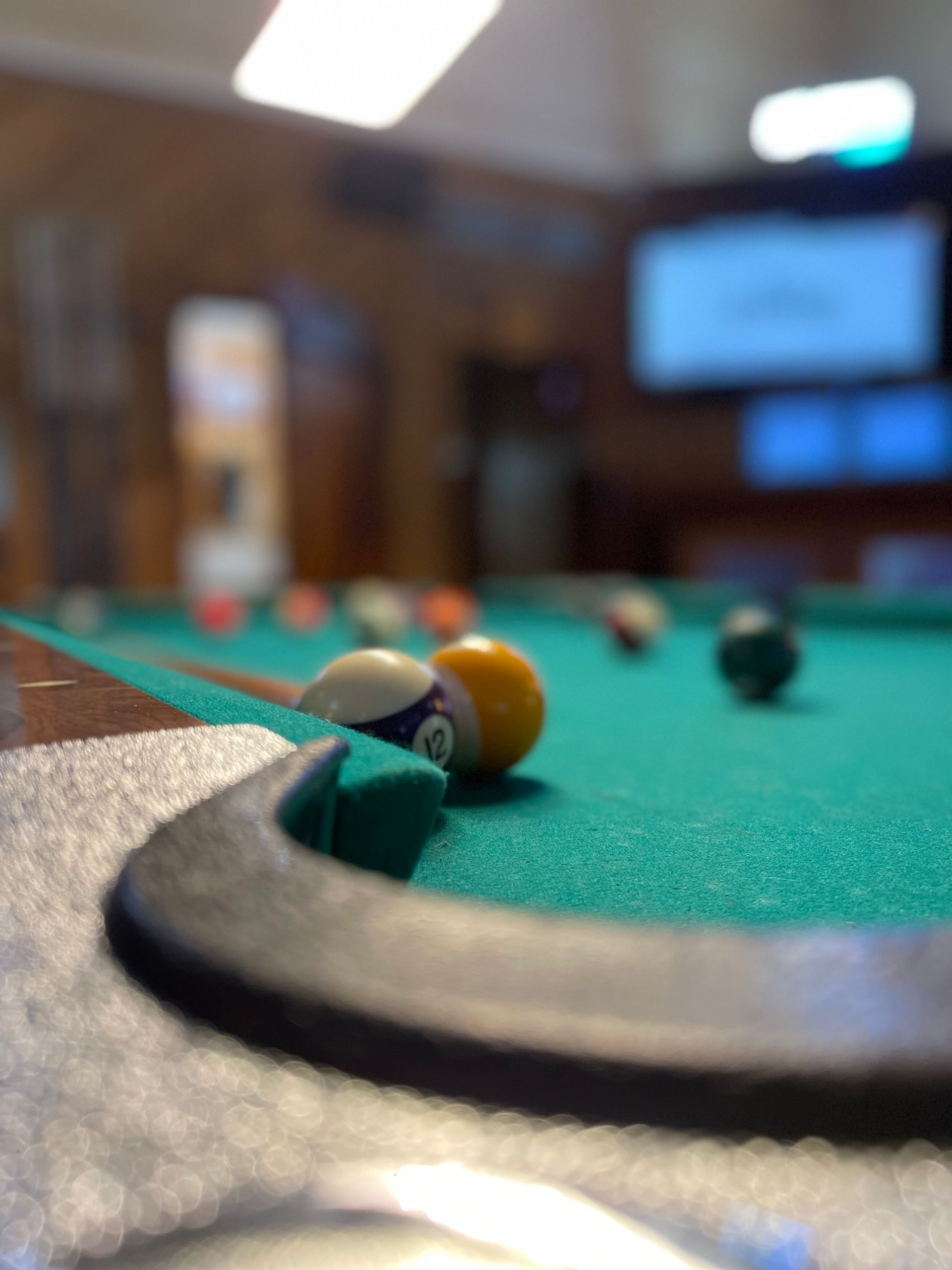 A pool table with balls and cues on it