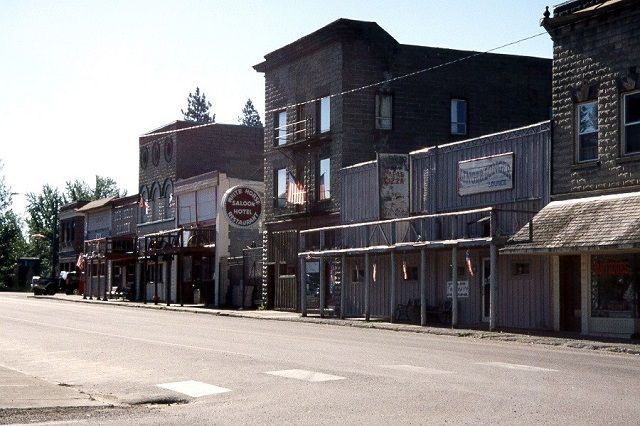 A row of buildings on the side of a street with a sign that says ' abercrombie & fitch ' on it