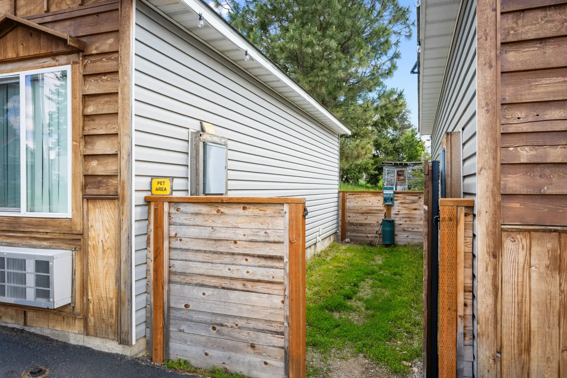 There is a wooden fence between two houses.