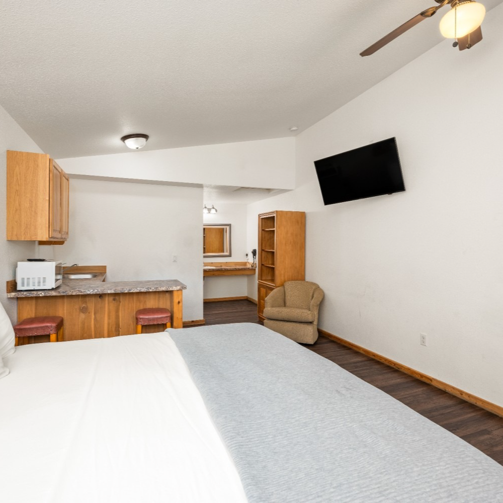 A bedroom with a large bed and a flat screen tv