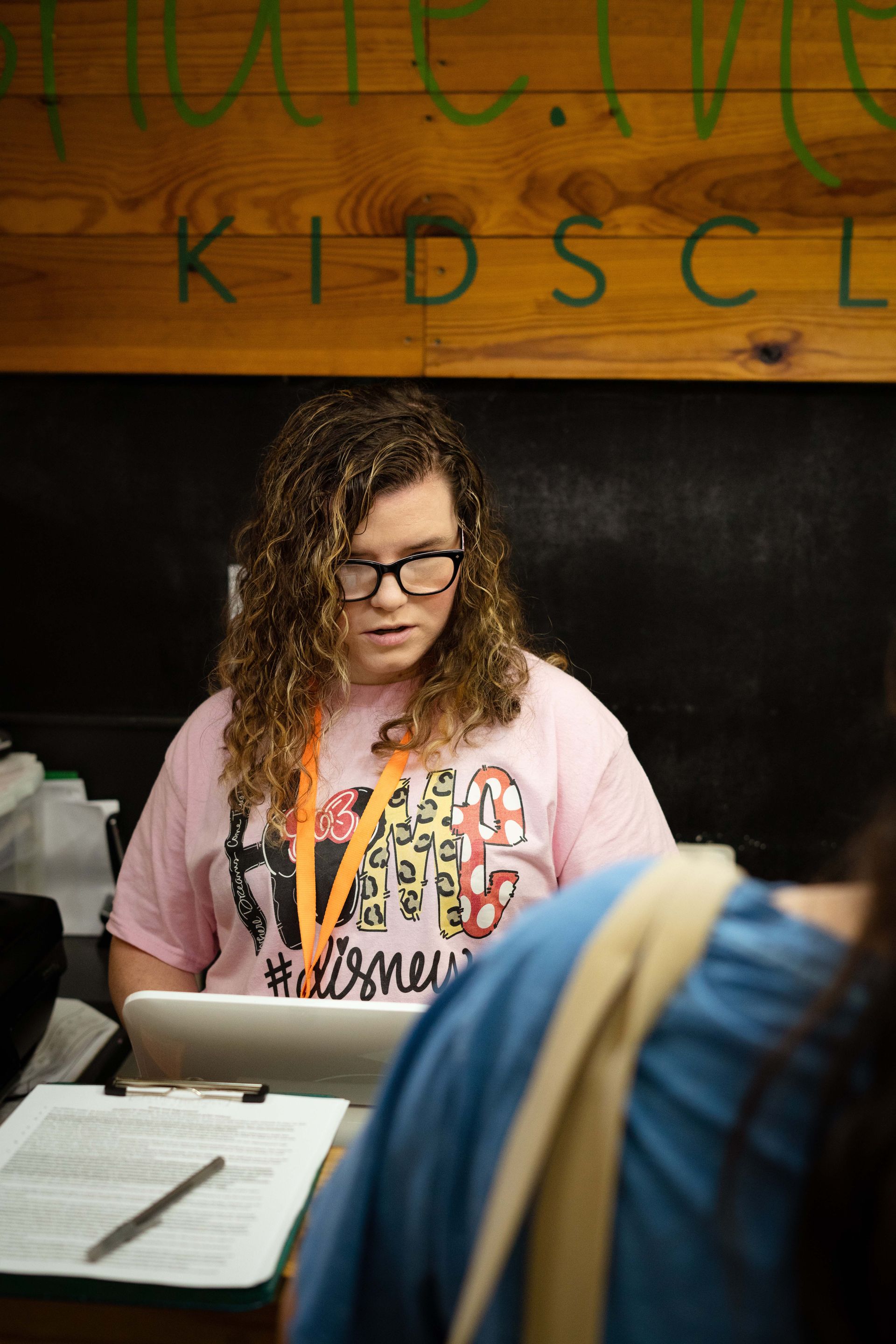A woman is sitting at a desk using a laptop computer.