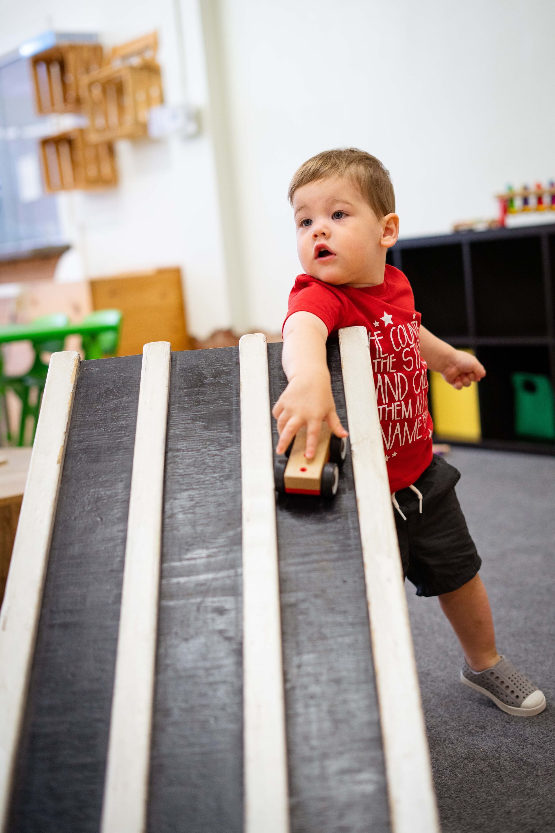 Little boy playing a toy car