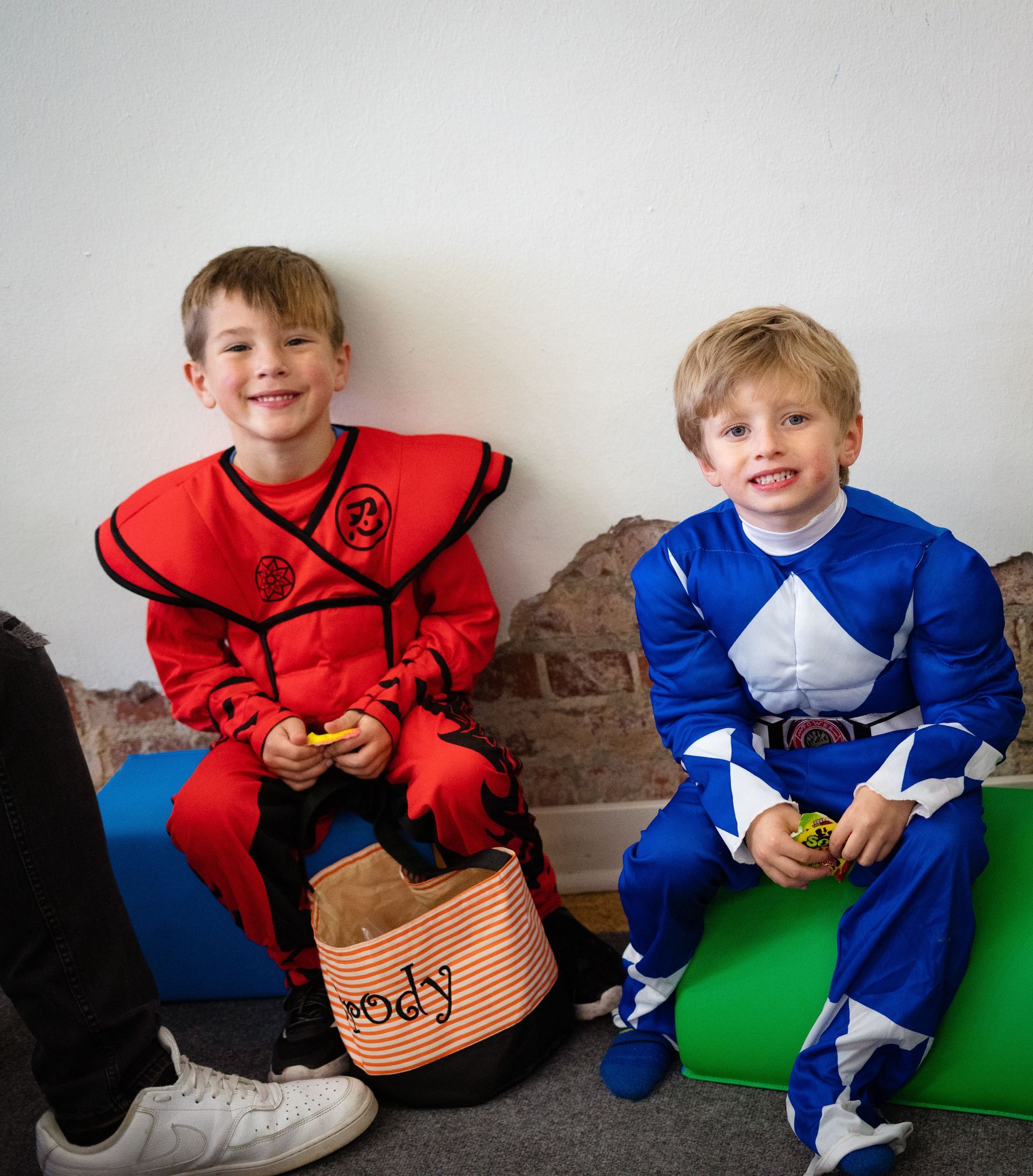 Two boys dressed in costumes are sitting next to each other