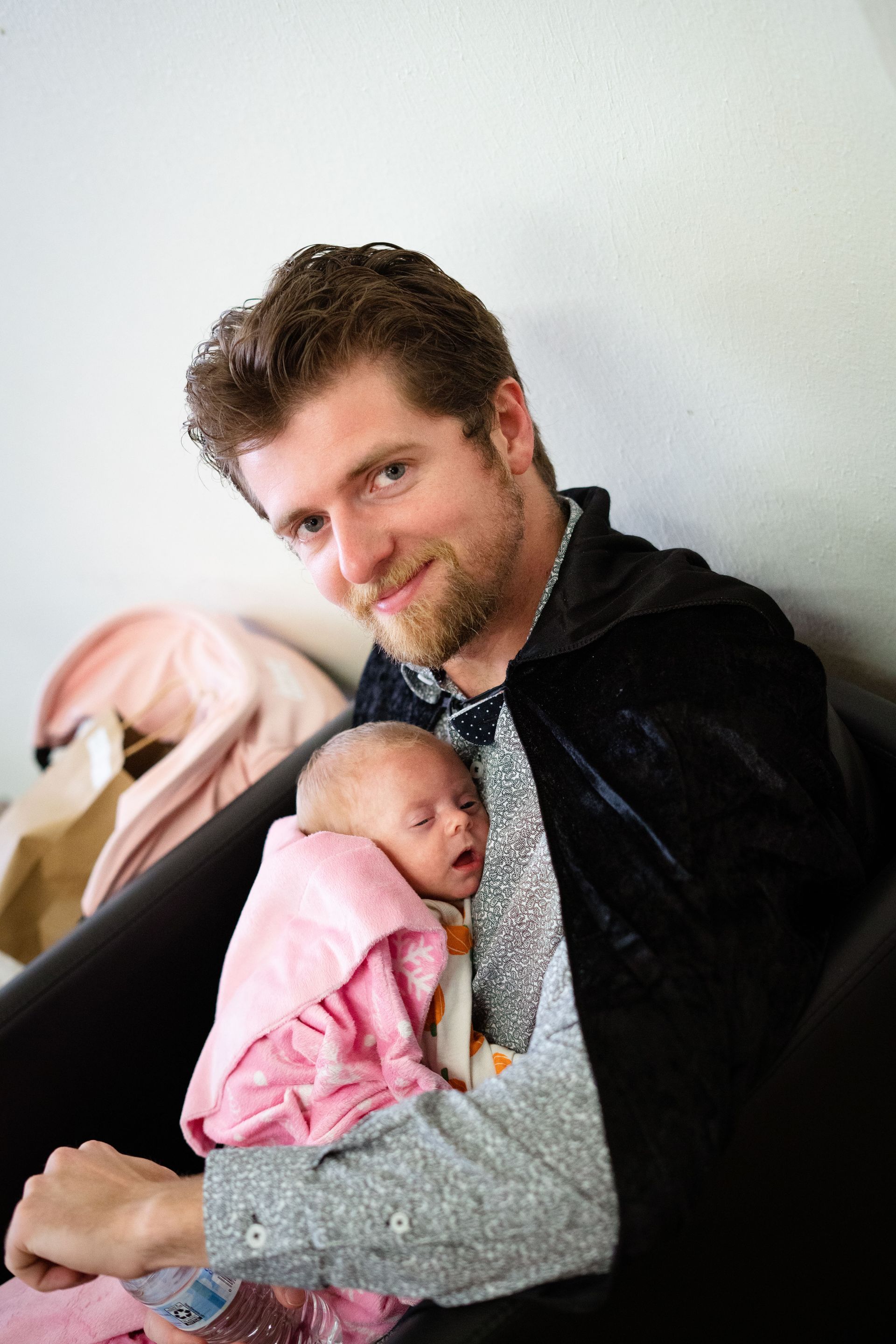 A man is holding a baby in his arms.