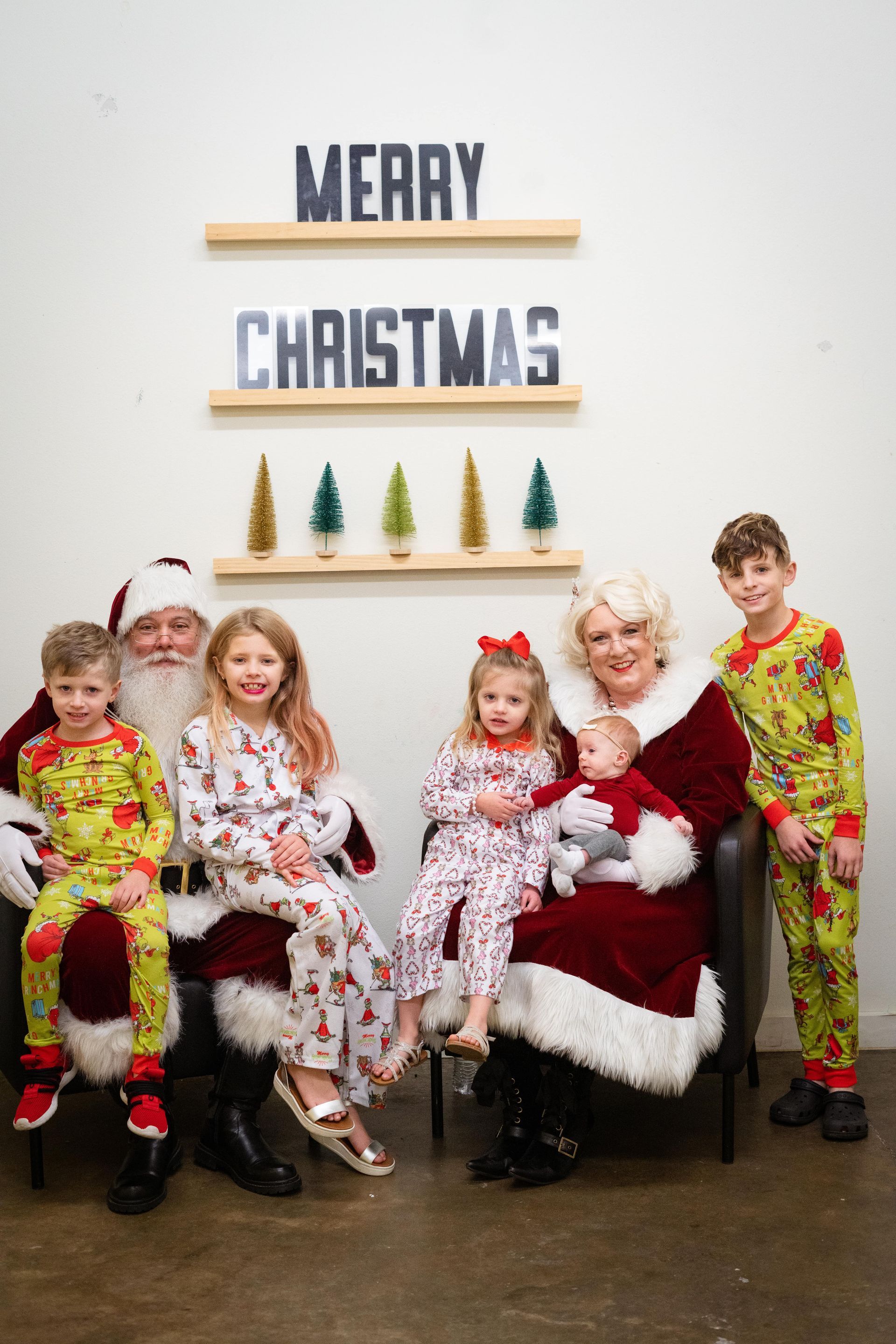 A group of children are posing for a picture with santa claus.