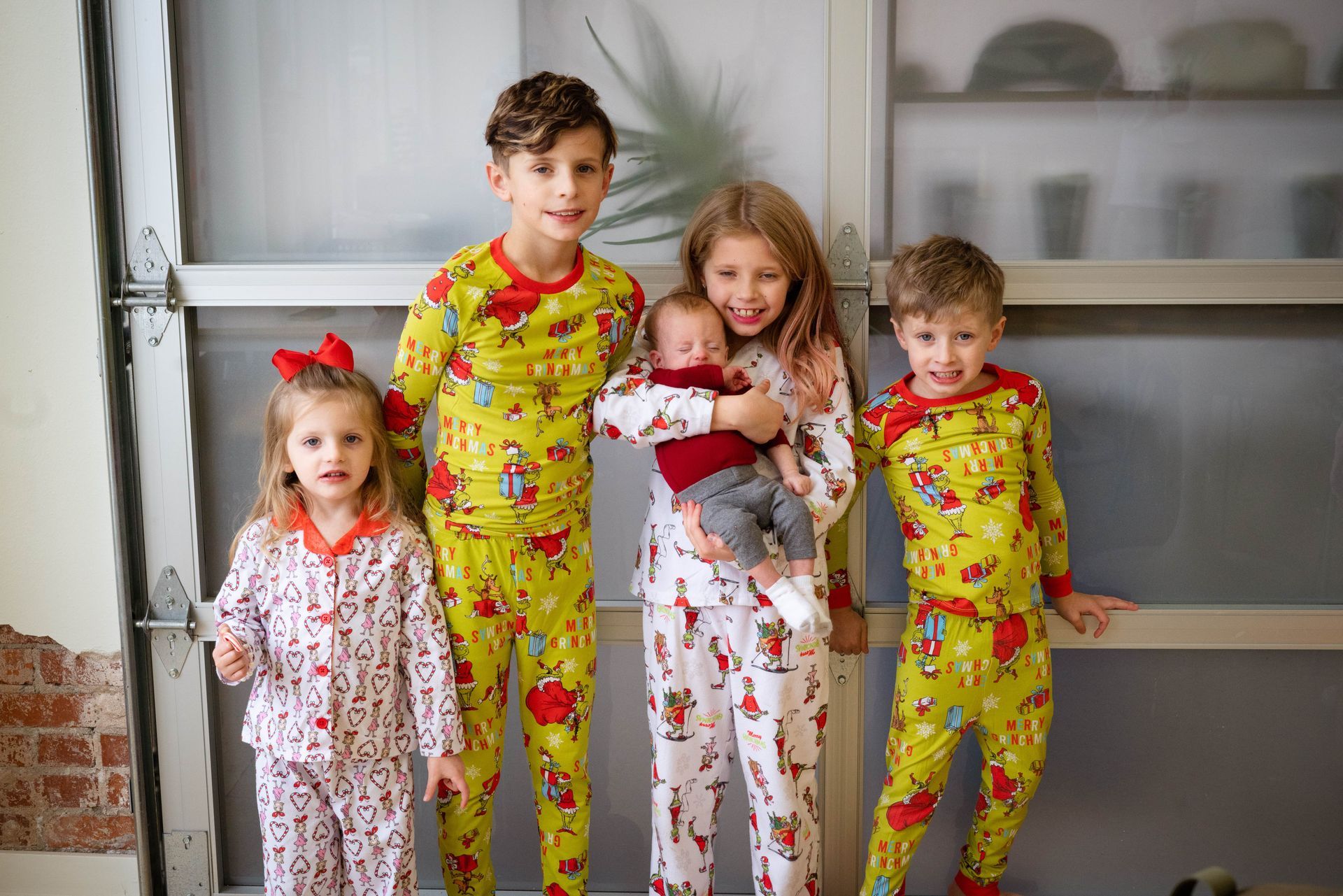 A group of children wearing pajamas are standing next to each other.