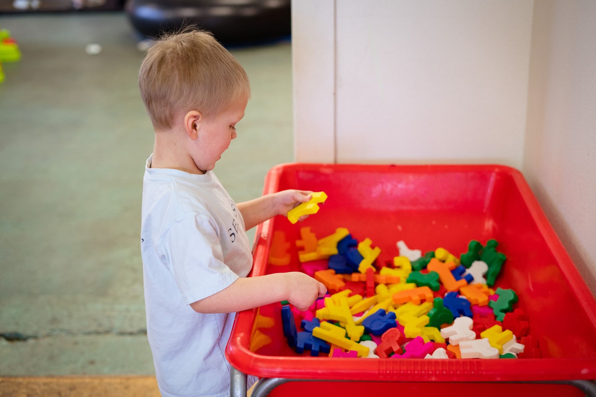 Kid playing with animal toys