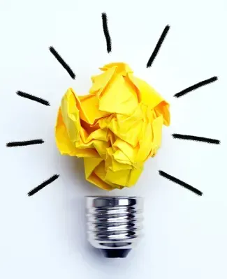 Yellow crumpled paper in a lightbulb socket, with drawn radiating lines.