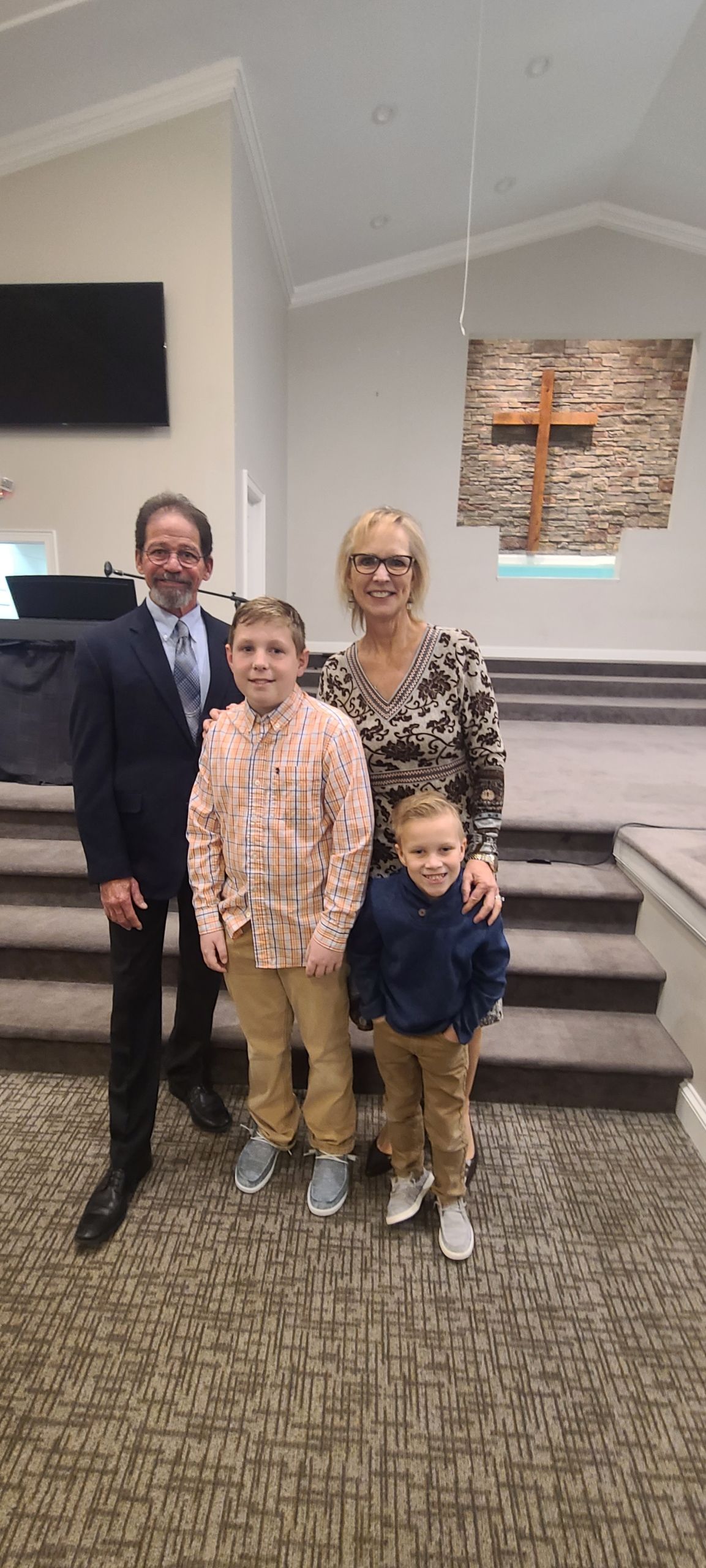 A family is posing for a picture in a church.