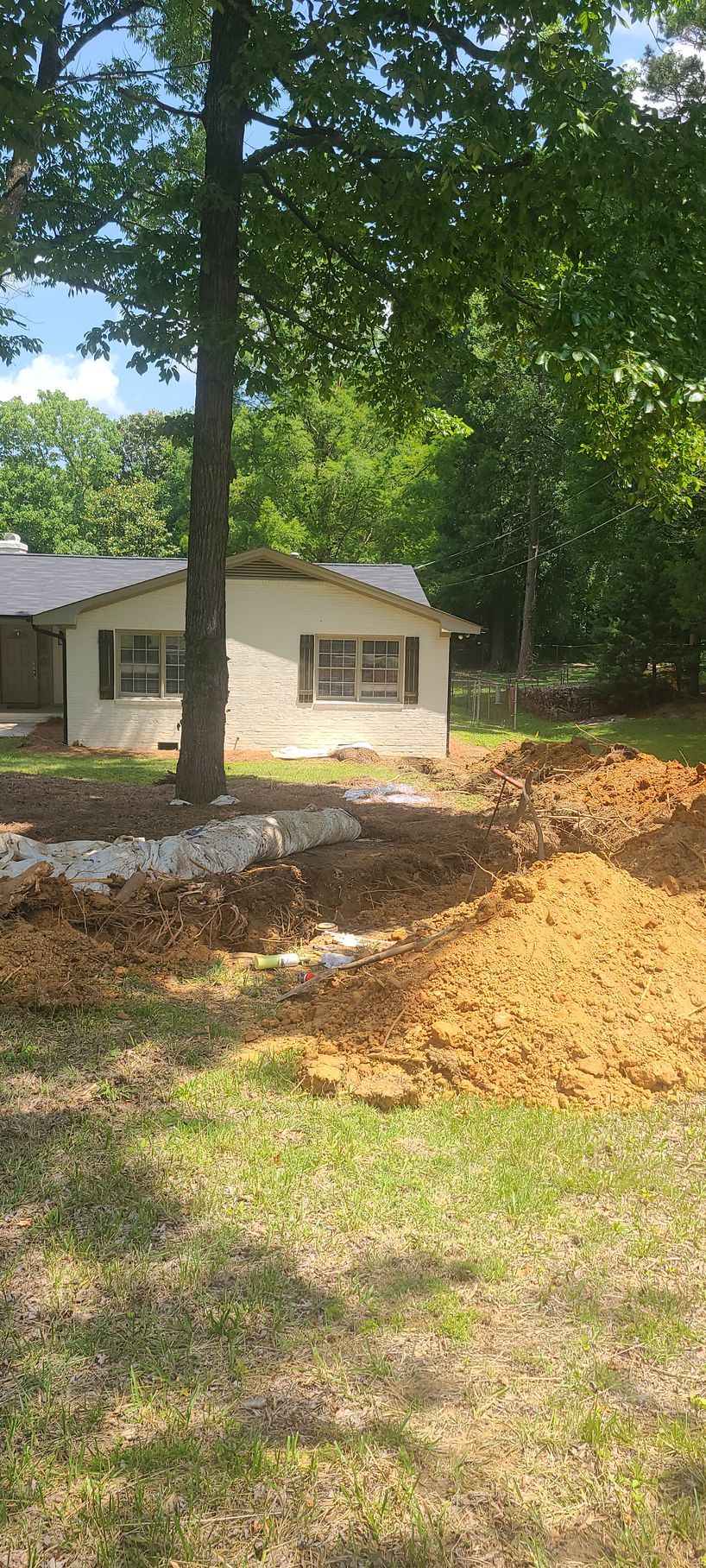 A bunch of pipes are coming out of a hole in the wall.