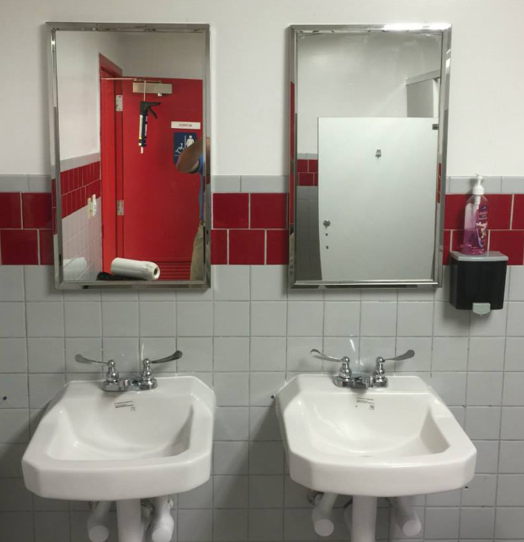 A bathroom with two sinks and two mirrors
