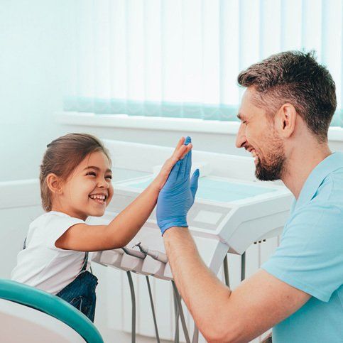 A Child and a Dentist High Five — Hickory, NC — McDonald Family Dentistry
