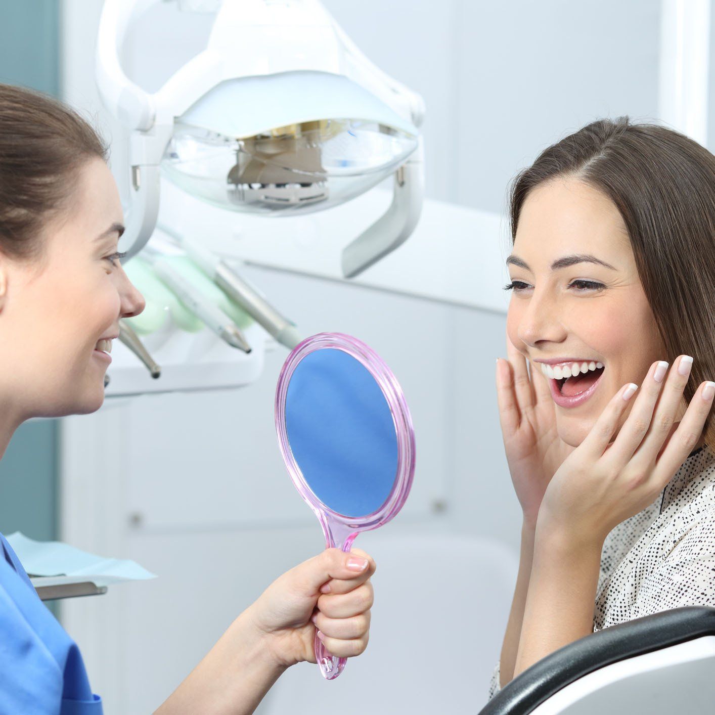 Happy Woman Looking at the Mirror — Hickory, NC — McDonald Family Dentistry