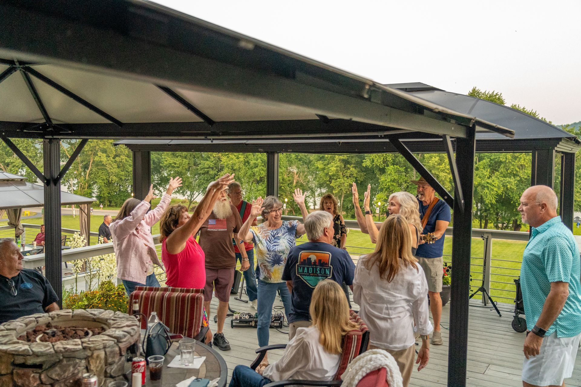 A group of people are dancing on the patio at Riverboat Inn.