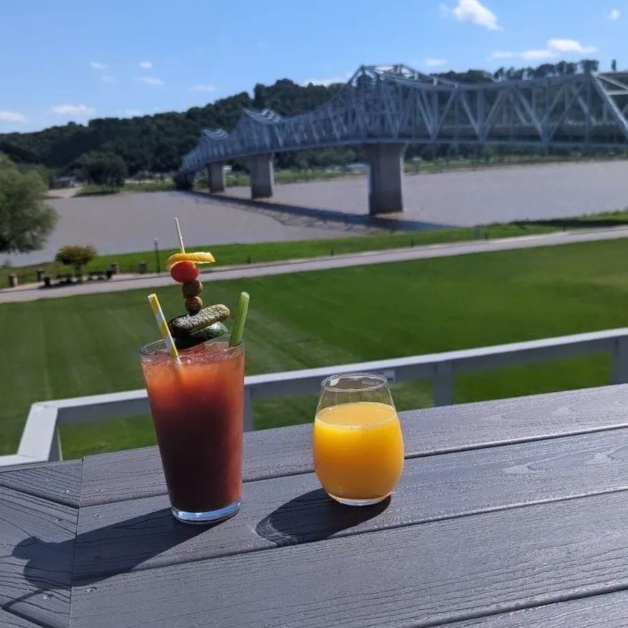2 drinks sitting on the deck of Riverboat Inn.