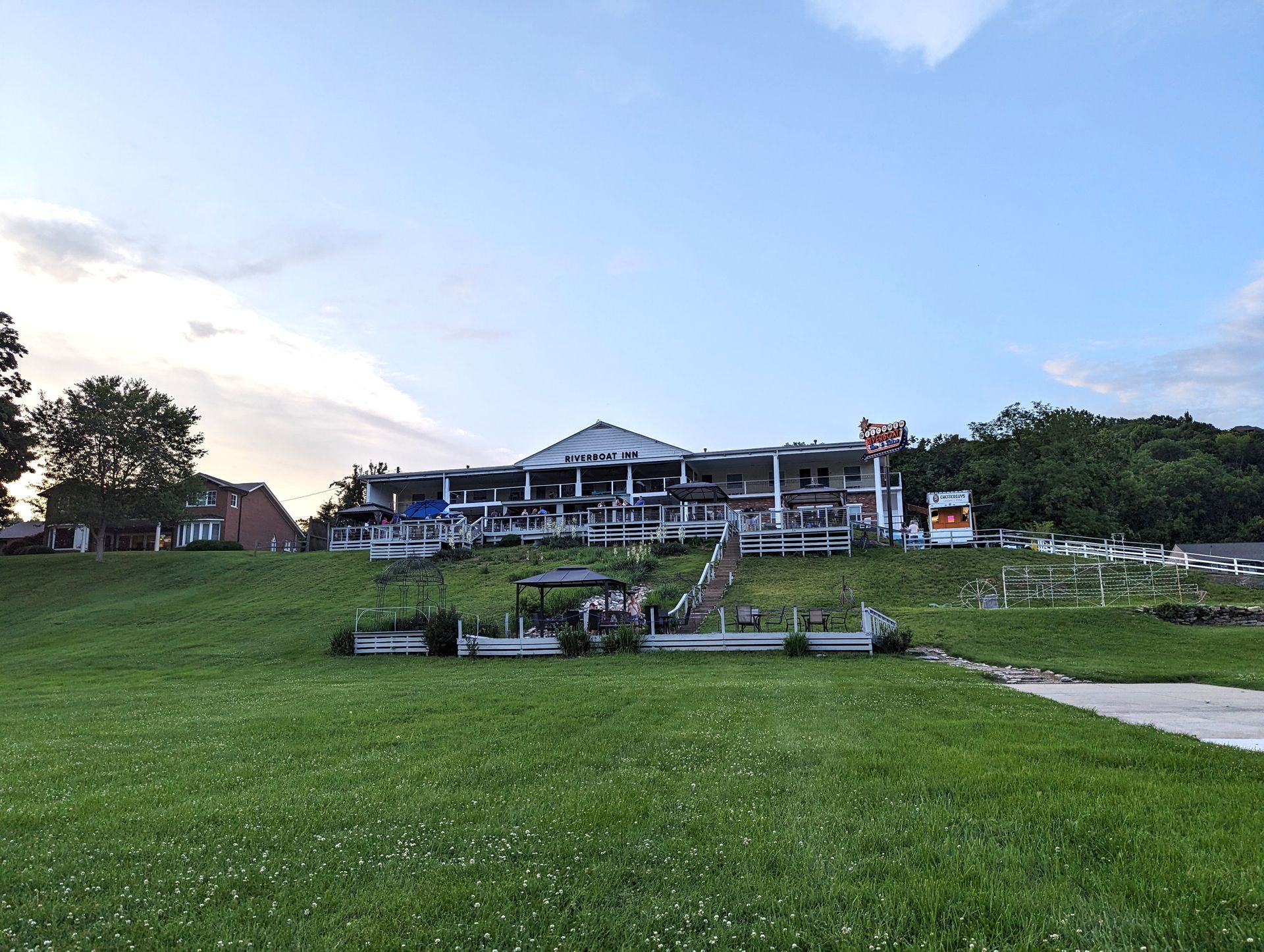 Riverboat Inn sitting on top of a grassy hill.