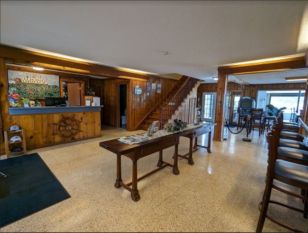 A hotel lobby with a wooden table and chairs.