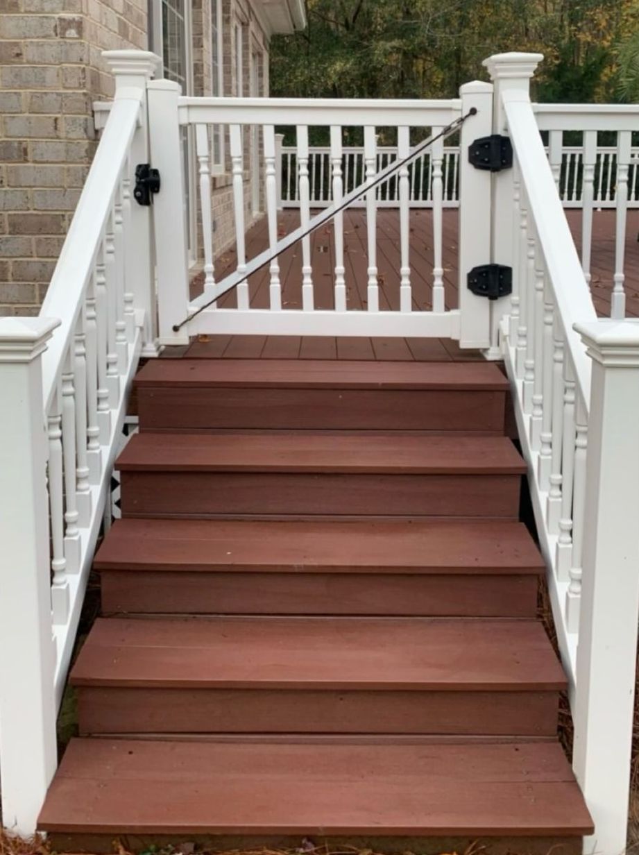 A person is spraying water on a piece of wood with a hose.