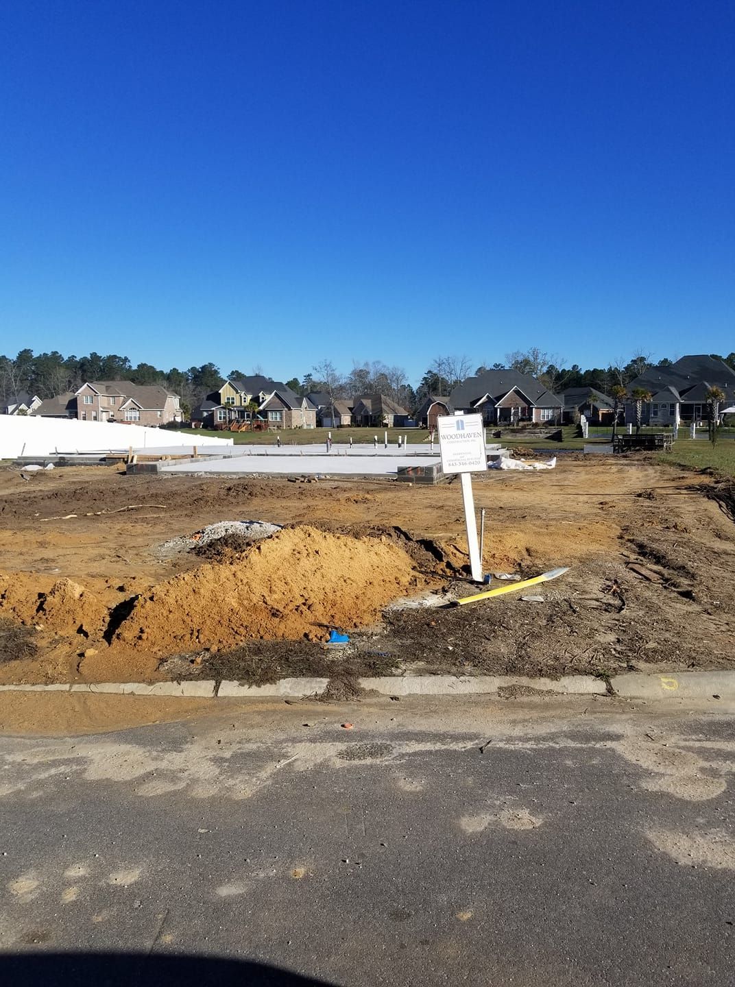 A construction site with a sign in the middle of it.