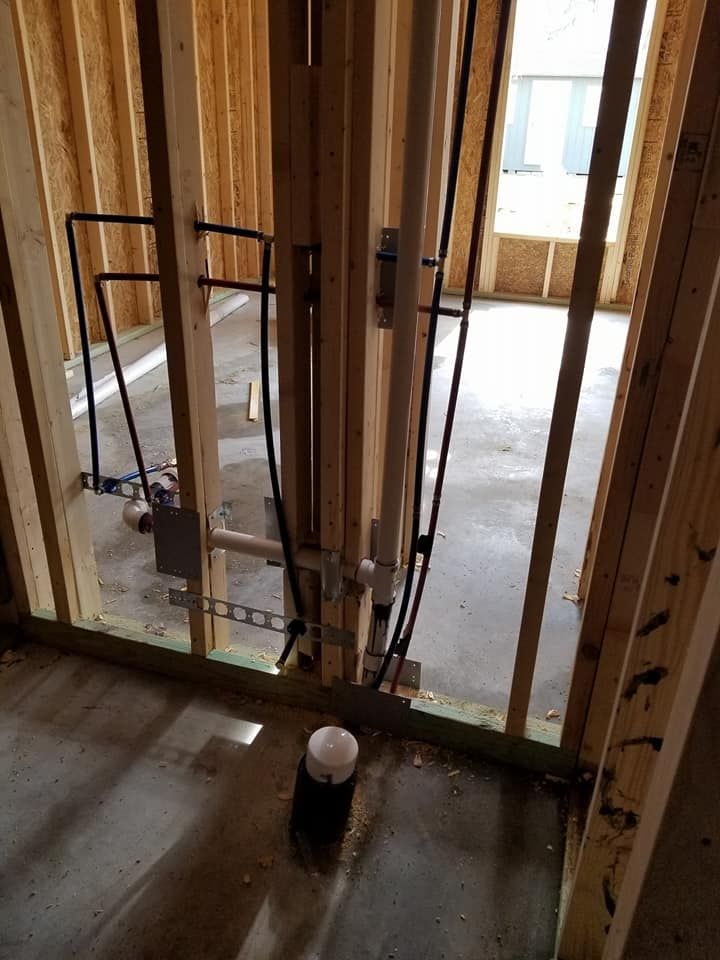 A room with wooden walls and pipes in it