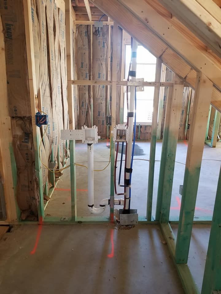 A room in a house under construction with a red line on the floor.
