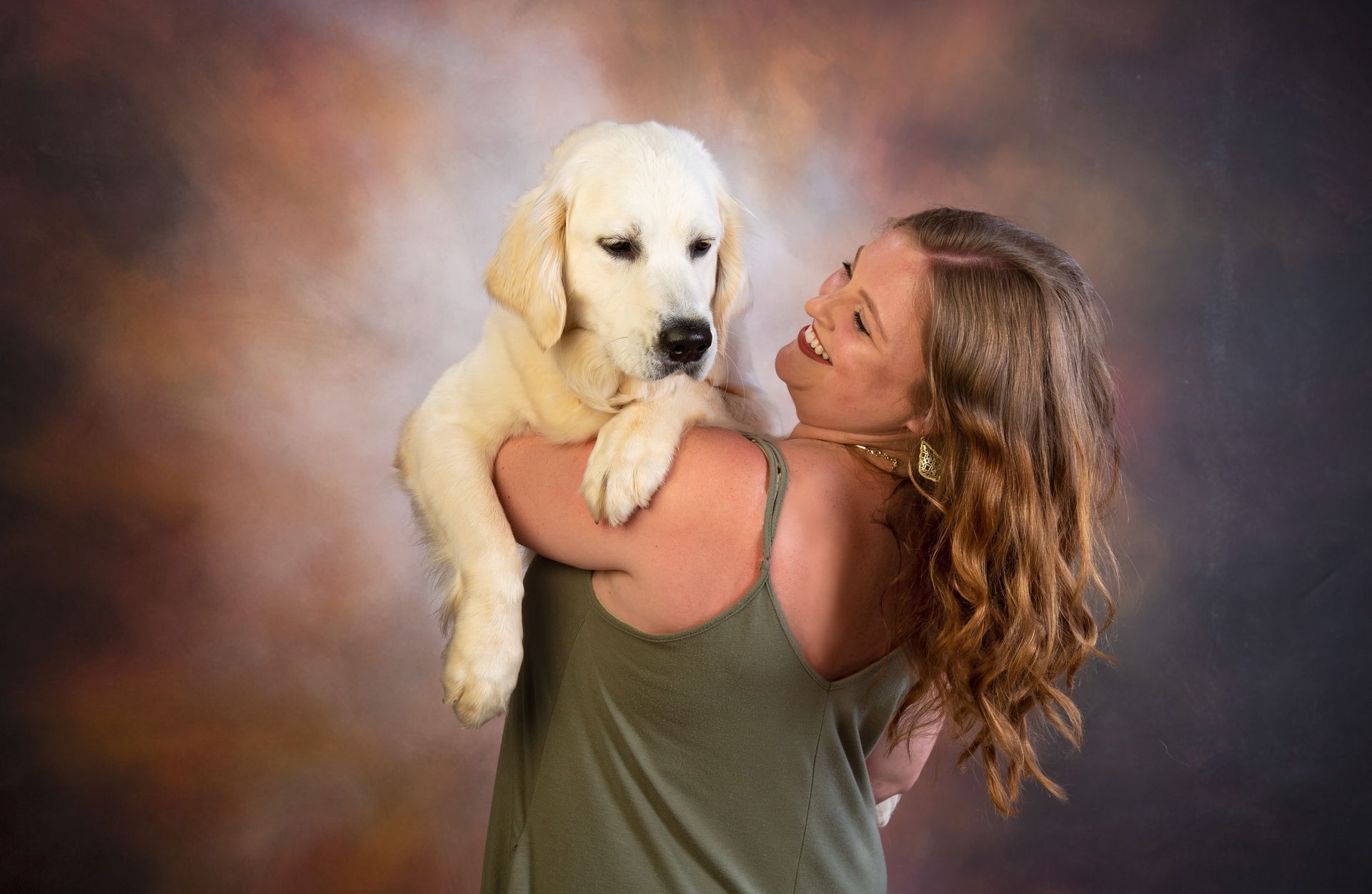 A woman is holding a puppy in her arms.