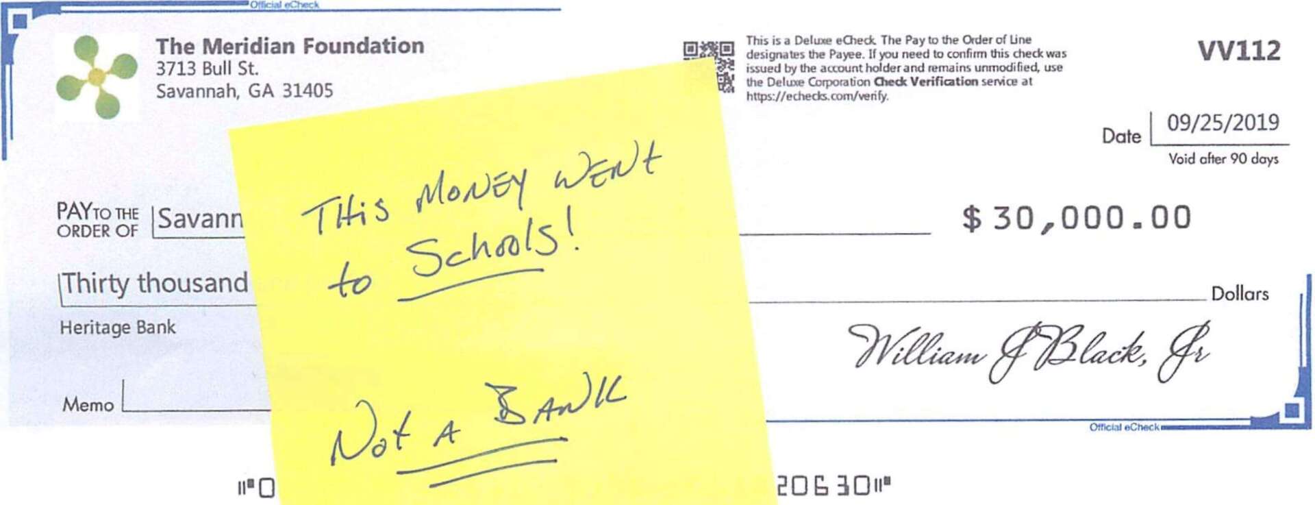 A check with a note on it that says this money went to schools