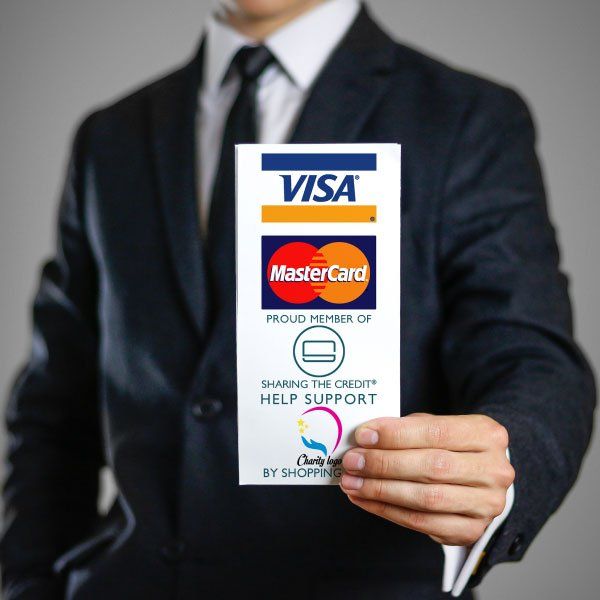 A man in a suit and tie is holding a visa mastercard sign