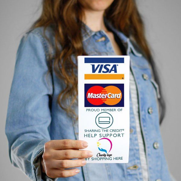 A woman in a denim jacket is holding a visa mastercard card