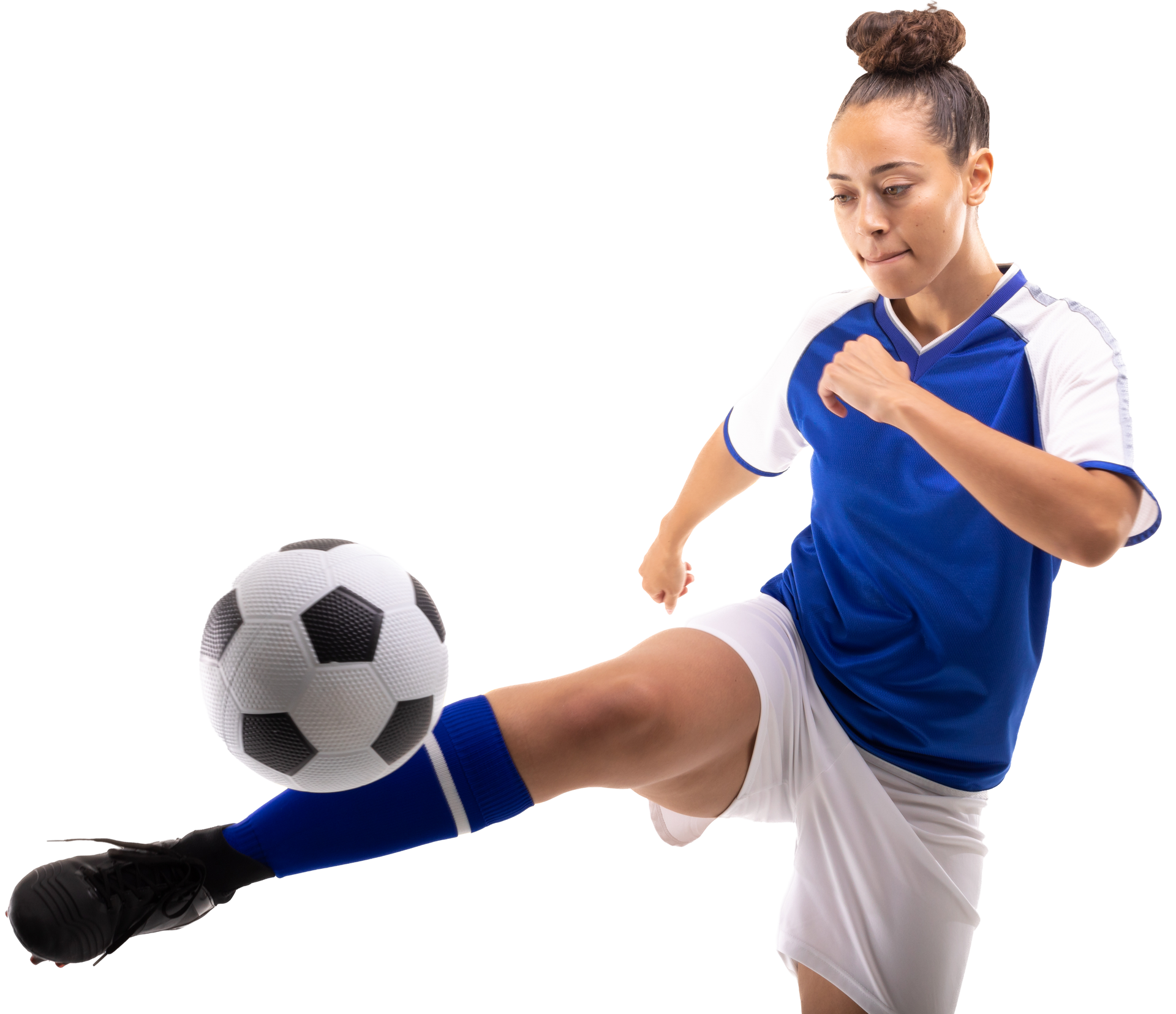 Female soccer player in blue and white uniform kicking a soccer ball.