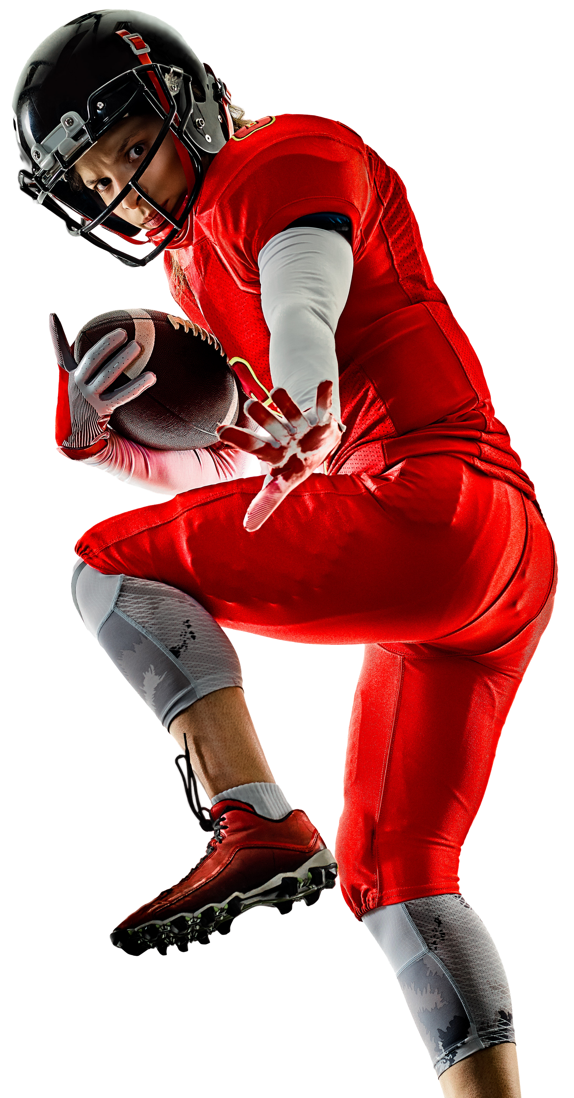 Football player in red uniform running with ball, eyes focused, white background.