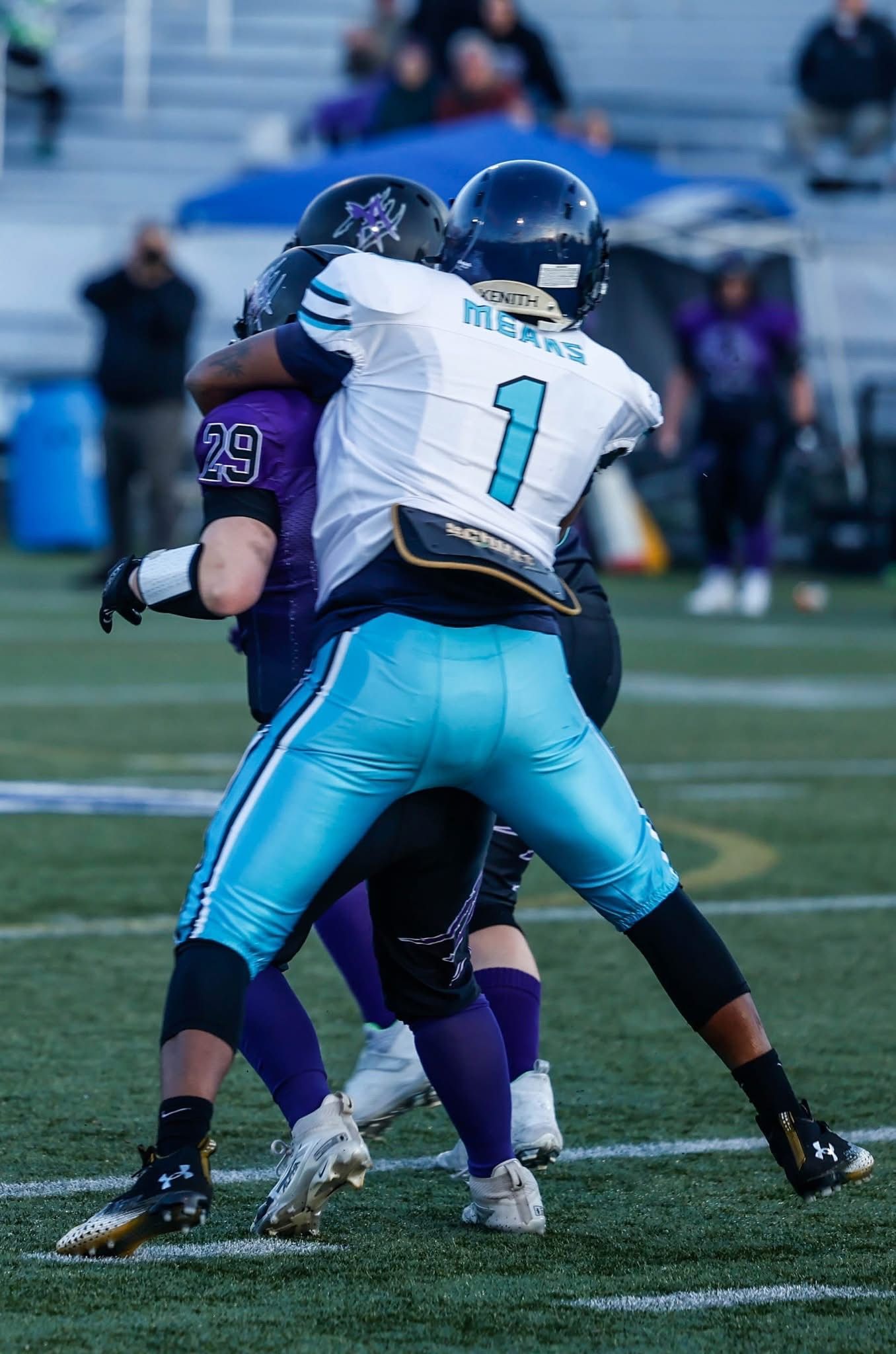 A football player in red uniform running with the ball, wearing a helmet.