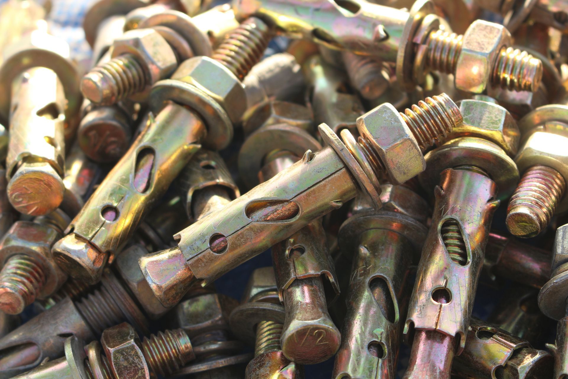 A pile of nuts and bolts are sitting on a table.